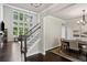 Open-concept living area featuring a staircase, hardwood floors, and lots of natural light from large windows at 147 Longleaf Dr, Canton, GA 30114