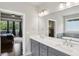 Main bathroom with double sinks, a soaking tub, and view to the main bedroom at 147 Longleaf Dr, Canton, GA 30114