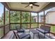 Inviting screened porch with ceiling fan, seating and view to the wooded backyard at 147 Longleaf Dr, Canton, GA 30114