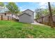 A spacious backyard, featuring lush green grass and a new constructed grey home at 1521 Sylvan Sw Rd, Atlanta, GA 30310