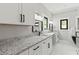 Bright bathroom featuring double vanity with granite countertop and modern black hardware at 1521 Sylvan Sw Rd, Atlanta, GA 30310
