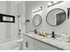 Modern bathroom featuring granite countertops, double sinks, and black hardware at 1521 Sylvan Sw Rd, Atlanta, GA 30310