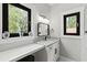 Light and airy bathroom vanity with granite countertop and black hardware near bright window at 1521 Sylvan Sw Rd, Atlanta, GA 30310