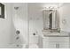 Bright bathroom with a shower-tub combination, updated vanity and granite countertop at 1521 Sylvan Sw Rd, Atlanta, GA 30310