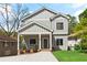 Charming two-story home with gray siding, white trim, inviting front porch, and a well-manicured front yard at 1521 Sylvan Sw Rd, Atlanta, GA 30310