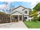 Charming two-story home with inviting front porch, well-manicured lawn, and professional landscaping at 1521 Sylvan Sw Rd, Atlanta, GA 30310