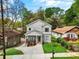 A stylish two-story home showcasing a well-maintained lawn, lovely landscaping, and inviting curb appeal at 1521 Sylvan Sw Rd, Atlanta, GA 30310