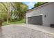 A detached garage with a concrete driveway extension and a backyard with plenty of green space at 1521 Sylvan Sw Rd, Atlanta, GA 30310