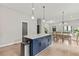 Open-concept layout features a kitchen island, flowing seamlessly into the dining and living areas for easy entertaining at 1521 Sylvan Sw Rd, Atlanta, GA 30310