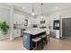 Modern kitchen with an island, stainless steel appliances, and white cabinets offers a functional design at 1521 Sylvan Sw Rd, Atlanta, GA 30310