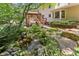 Landscaped backyard featuring a tranquil pond and custom water feature at 5240 Arrie Way, Atlanta, GA 30360