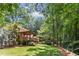 Spacious backyard with a screened-in porch and mature trees at 5240 Arrie Way, Atlanta, GA 30360