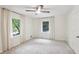 An airy bedroom with a ceiling fan and natural light from two windows at 5240 Arrie Way, Atlanta, GA 30360