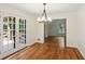 Bright dining room featuring hardwood floors, chandelier, and french doors to outdoor space at 5240 Arrie Way, Atlanta, GA 30360