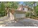 Charming two-story home with a two car garage and lush greenery at 5240 Arrie Way, Atlanta, GA 30360