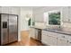 Kitchen with stainless steel appliances, granite countertops, and views of the backyard at 5240 Arrie Way, Atlanta, GA 30360