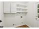 Laundry room featuring built in shelving, cabinets, and access to the exterior at 5240 Arrie Way, Atlanta, GA 30360