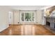 Sun-drenched living room featuring a brick fireplace, hardwood floors and large windows at 5240 Arrie Way, Atlanta, GA 30360