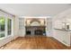 Bright living room with a brick fireplace, built-in bookshelves, and hardwood floors at 5240 Arrie Way, Atlanta, GA 30360