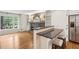 Open living room with a breakfast bar overlooking a brick fireplace and built in shelves at 5240 Arrie Way, Atlanta, GA 30360