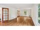 Open living room featuring hardwood floors, large windows, and neutral-colored walls at 5240 Arrie Way, Atlanta, GA 30360