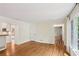 Hardwood floor open floor plan with french doors, white walls, and view to kitchen at 5240 Arrie Way, Atlanta, GA 30360