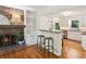 Bright living room with a brick fireplace, built-in bookshelves, and view to kitchen at 5240 Arrie Way, Atlanta, GA 30360