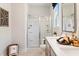 Bright bathroom with a double vanity, framed mirror, and glass enclosed shower at 102 Sheryl Way, Loganville, GA 30052