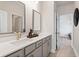 Bathroom featuring double sinks with modern faucets, framed mirrors and tile flooring at 102 Sheryl Way, Loganville, GA 30052
