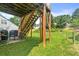 Backyard view beneath deck featuring green grass and wooded privacy at 3485 Palisade Lake Dr, Duluth, GA 30096