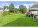 Expansive backyard with lush green grass, mature trees, and an elevated deck with stairs at 3485 Palisade Lake Dr, Duluth, GA 30096