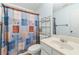 Bathroom featuring a patterned shower curtain, toilet, vanity, and metal shelving at 3485 Palisade Lake Dr, Duluth, GA 30096