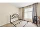 A bedroom showcasing simple décor, including sheer curtains and a metal bed frame at 3485 Palisade Lake Dr, Duluth, GA 30096
