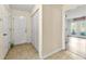Hallway showcasing neutral paint, a tile floor, and access to a sunroom at 3485 Palisade Lake Dr, Duluth, GA 30096
