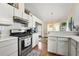 Well-lit kitchen featuring white cabinets, modern stainless steel appliances, and hardwood flooring at 3485 Palisade Lake Dr, Duluth, GA 30096