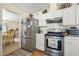 Functional kitchen with stainless steel appliances, white cabinets, and an adjacent dining area at 3485 Palisade Lake Dr, Duluth, GA 30096