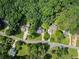 An aerial view shows the property nestled among mature trees in a residential neighborhood at 5510 Pilgrim Point Ext, Cumming, GA 30041