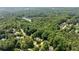 Scenic aerial view of the property surrounded by lush greenery, offering privacy and tranquility at 5510 Pilgrim Point Ext, Cumming, GA 30041