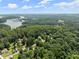 Stunning aerial view of lush greenery and lakeside living with ample tree coverage at 5510 Pilgrim Point Ext, Cumming, GA 30041