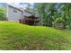 A large backyard featuring a wooden deck and mature trees at 5510 Pilgrim Point Ext, Cumming, GA 30041