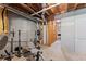 Unfinished basement with exposed pipes, concrete walls, and space for gym equipment at 5510 Pilgrim Point Ext, Cumming, GA 30041