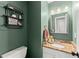 A cute half bathroom with a granite vanity, rustic decor, and green walls at 5510 Pilgrim Point Ext, Cumming, GA 30041
