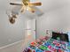 Bedroom with carpet floors, ceiling fan and cartoon themed comforter on the bed at 5510 Pilgrim Point Ext, Cumming, GA 30041