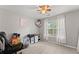 Bedroom with a window, fan, carpet floors and walls painted light gray color at 5510 Pilgrim Point Ext, Cumming, GA 30041