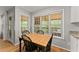 Bright breakfast nook featuring a wooden table set and natural light from large windows at 5510 Pilgrim Point Ext, Cumming, GA 30041