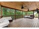 Large wooden deck with comfortable outdoor seating and ceiling fans at 5510 Pilgrim Point Ext, Cumming, GA 30041