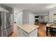 Open concept kitchen with a center island, stainless steel appliances, and views into the living room at 5510 Pilgrim Point Ext, Cumming, GA 30041