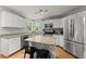 Modern kitchen with stainless steel appliances, an island with bar seating, and white cabinets at 5510 Pilgrim Point Ext, Cumming, GA 30041