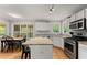 This kitchen showcases stainless appliances, granite countertops, and a connected breakfast nook area at 5510 Pilgrim Point Ext, Cumming, GA 30041