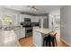 Open kitchen featuring stainless steel appliances, granite countertops, and a center island with seating at 5510 Pilgrim Point Ext, Cumming, GA 30041